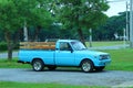 Beautiful vintage blue pickup truck, old Mazda Familia car parked on the street outdoors.
