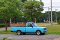Beautiful vintage blue pickup truck, old Mazda Familia car parked on the street outdoors.