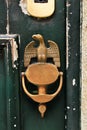 Vintage door knocker eagle shaped on wooden door Royalty Free Stock Photo