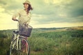 Beautiful vintage girl sitting next to bike, summer time Royalty Free Stock Photo