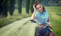 Beautiful vintage girl sitting next to bike, summer time Royalty Free Stock Photo