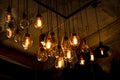 Beautiful vintage luxury light bulb hanging decor glowing in dark. Royalty Free Stock Photo