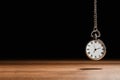 Beautiful vintage pocket watch with silver chain on black background above table, space for text. Hypnosis session Royalty Free Stock Photo