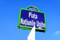 Vintage street sign showing Piata Natiunile Unite (United Nations Square) displayed on an street in the city center of Royalty Free Stock Photo