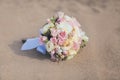 Beautiful vintage wedding bouquet flowers roses sand beach Royalty Free Stock Photo