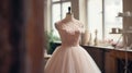 Beautiful vintage wedding dress on a mannequin in a designer's studio with flowers, gentle powdery pink colors Royalty Free Stock Photo