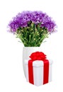 Beautiful violet flowers in vase and gift box isolated on white Royalty Free Stock Photo