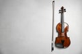 Beautiful violin and bow on grey table, flat lay. Space for text Royalty Free Stock Photo