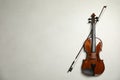 Beautiful violin and bow on grey table, flat lay. Space for text Royalty Free Stock Photo
