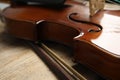 Beautiful violin and bow on wooden table