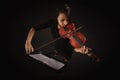 Beautiful Violinist Woman playing violin on black background Royalty Free Stock Photo
