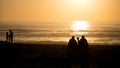 Beautiful vivid beach sunset with silhouetted people over Atlantic Ocean in Vila do Conde, Porto, Portugal Royalty Free Stock Photo