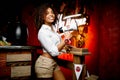 Beautiful waitress in a bar in white shirt