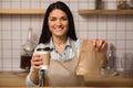 Waitress holding coffee to go and take away food Royalty Free Stock Photo