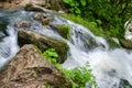 Beautiful wallpaper milk waterfall flow rapid stream. Caucasus rocky mountain river in forest. Isichenko waterfall, Guamka, Mezmay