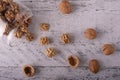 Beautiful walnut kernels poured out of an open glass jar, with whole nuts in shells and empty shells lying nearby.