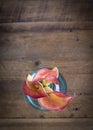 Vertical overhead shot of three calla lilies with room for text on distressed pine table top