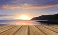 Beautiful warm vibrant sunrise over ocean with cliffs and rocks