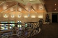 Interior architecture of room with warm wood tones and blown glass chandelier, Coastal Arts Center, Orange Beach, Alabama, 2018