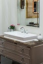 A beautiful washbasin with a silver chrome tap and fittings. Marble sink, led mirror, white dispenser, modern bathroom design Royalty Free Stock Photo