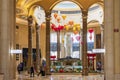 A beautiful water fountain with statues, Chinese lanterns, gold coins and lush green plants at The Venetian Resort and Hotel