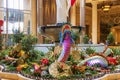 A beautiful water fountain with statues, Chinese lanterns, gold coins and lush green plants at The Venetian Resort and Hotel