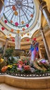 A beautiful water fountain with statues, tall pillars, Chinese lanterns and lush green plants at The Venetian Resort and Hotel