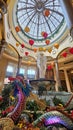 A beautiful water fountain with statues, tall pillars, Chinese lanterns and lush green plants at The Venetian Resort and Hotel