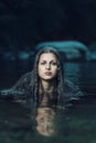 Beautiful water nymph in dark cyan stream Royalty Free Stock Photo