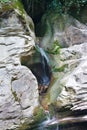 Beautiful water stream flows from mountain cave
