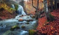 Beautiful waterfall in autumn forest in crimean mountains at sun Royalty Free Stock Photo