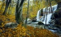 Beautiful waterfall in autumn forest in crimean mountains at sun Royalty Free Stock Photo