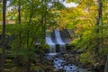 Beautiful waterfall in colorful autumn forest with red and orange leaves Royalty Free Stock Photo