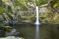 Beautiful waterfall falling over a pool of crystal clear water in O Courel