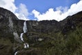 A beautiful waterfall falls from a high mountain, on the way to Lagoon 69. Huascaran National Park in the Sands of Peru Royalty Free Stock Photo