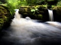 Beautiful waterfall flowing down from moss-covered rocks in the forest, wildlife of Scotland Royalty Free Stock Photo