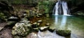 Beautiful waterfall flowing down from moss-covered rocks in the forest, wildlife of Scotland Royalty Free Stock Photo