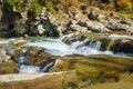 Beautiful waterfall in forest, fresh water flows between stones and rocks, wonderful landscape, wild nature`s beauty Royalty Free Stock Photo