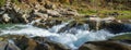 Beautiful waterfall in forest, fresh water flows between stones and rocks, wonderful landscape, wild nature`s beauty Royalty Free Stock Photo