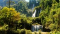 Beautiful waterfall in green tropical forest. Mountain jungle with limestone waterfalls cascades. Famous largest