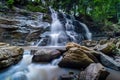 Beautiful waterfall in green tropical forest. View of the falling water with splash in rain season know as name Tad Mok, Chiang Royalty Free Stock Photo