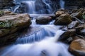 Beautiful waterfall in green tropical forest. View of the falling water with splash in rain season know as name Tad Mok, Chiang Royalty Free Stock Photo