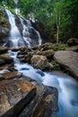 Beautiful waterfall in green tropical forest. View of the falling water with splash in rain season know as name Tad Mok, Chiang Royalty Free Stock Photo