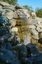 Beautiful waterfall in Japanese garden. Public landscape park of Krasnodar or Galician park, Russia Royalty Free Stock Photo