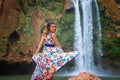 Beautiful waterfall in Morocco. Back of woman in beautiful dress fall Ouzoud. Exotic nature of North Africa, Royalty Free Stock Photo