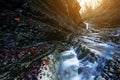 Beautiful waterfall at mountain river in colorful autumn forest with red and orange leaves at sunset. Nature landscape Royalty Free Stock Photo