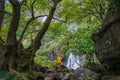 Beautiful waterfall with one person standing looking