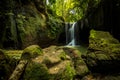 Beautiful waterfall in rainforest. Tropical landscape. Slow shutter speed, motion photography. Foreground with big stones. Royalty Free Stock Photo