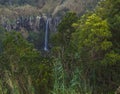 Beautiful waterfall Salto da Farinha falling from rocks in lush green rainforest vegetation, Sao Miguel, Azores