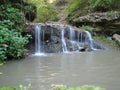 Beautiful waterfall. Spring weather. A small lake. Royalty Free Stock Photo